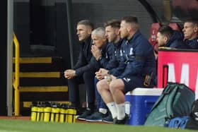 Preston North End manager Ryan Lowe watches the second half against Burnley alongside his coaching staff
