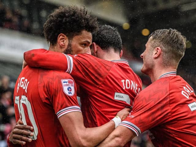 Lee Angol and his Morecambe team-mates celebrate the striker's weekend winner against Swindon Town Picture: Morecambe FC