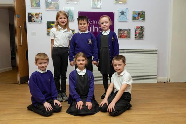 Pupil's in front of the school's motto ‘Living life in all its fulness’