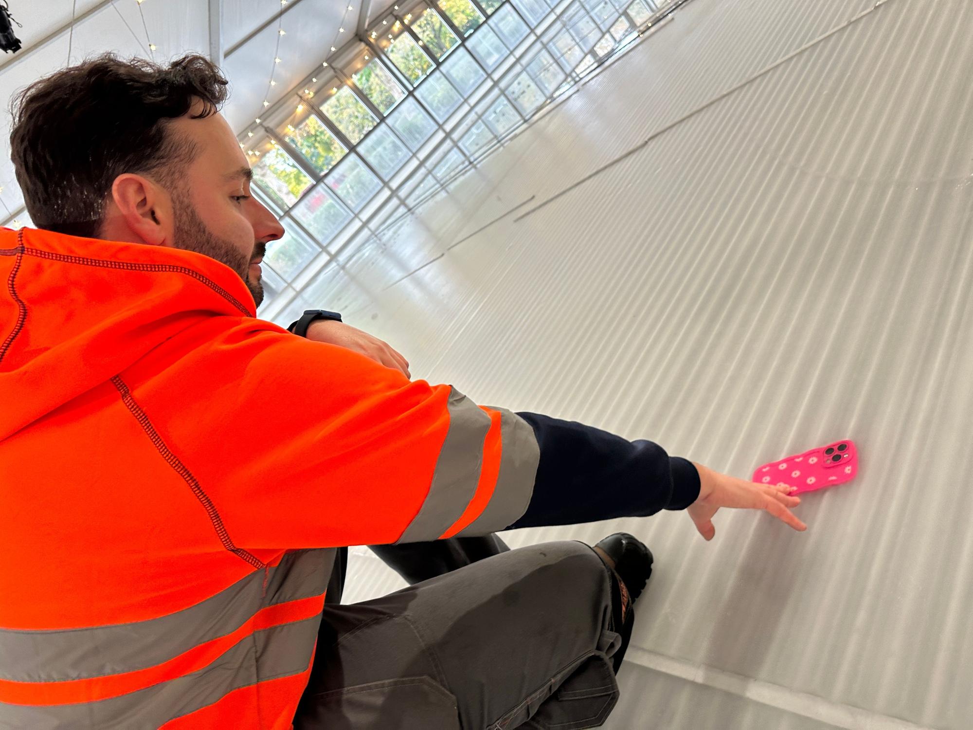 Workman drops daughter's i-phone on a soon-to-be frozen ice-rink and it's trapped under ice