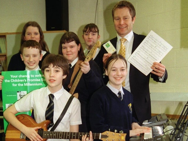 Richard Sharples, the education manager of the New Millennium Experience, with the 'Millennium Bugs' of Ribbleton Hall High School, Preston, who have written a song for to mark the turn of the century in 1999