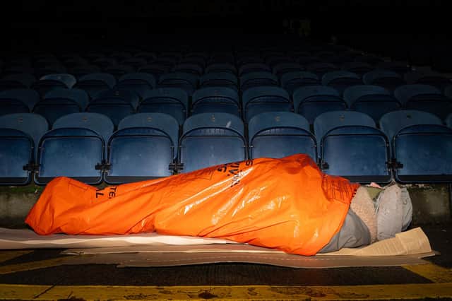 David Sergeant tries to keep warm during the big PNE Sleep out at Deepdale. Photo: Kelvin Lister-Stuttard