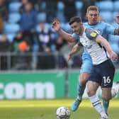 Preston North End defender Andrew Hughes gets the better of Coventry City striker Martyn Waghorn