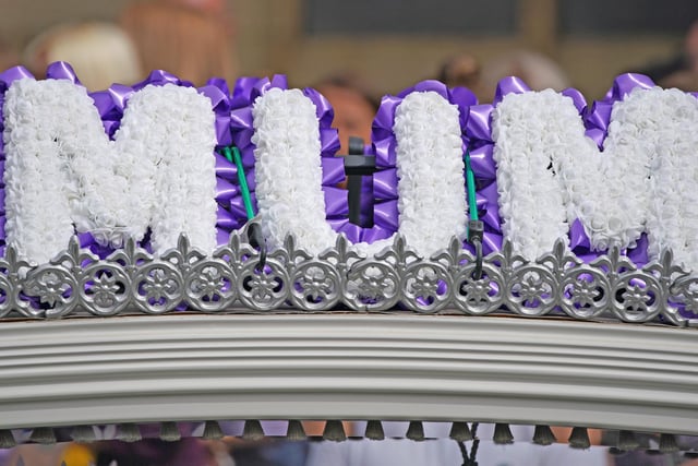 The carriage was topped with a beautiful floral tribute reading 'mum'. (Credit: PA/ Peter Byrne)