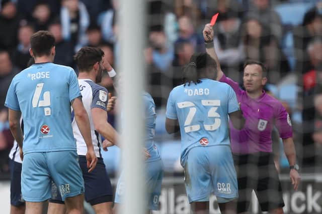 Coventry substitute Fankaty Dabo is shown the red card by referee Keith Stroud against Preston North End