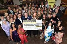 Guests at the ladies' day event, organised by CARES charity and held at Burnley's Penny Black, with the cheque for £250,000 to purchase vital equipment for the ELHT