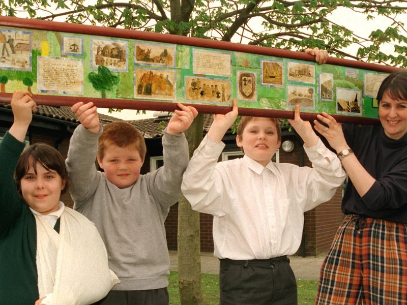 St. James' C.E. Primary School, Moss Side, Leyland pupils, from left, Rachel Anthony, Cameron Crook, and Chris Hindle, with classroom assistant and artist Rebecca Freear, and one of the murals