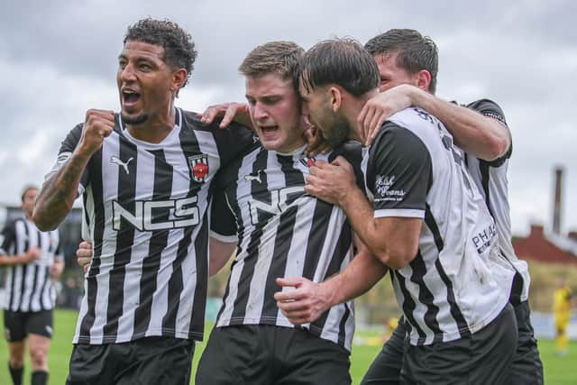 Elliot Taylor is mobbed after his equaliser against Brackley Town
