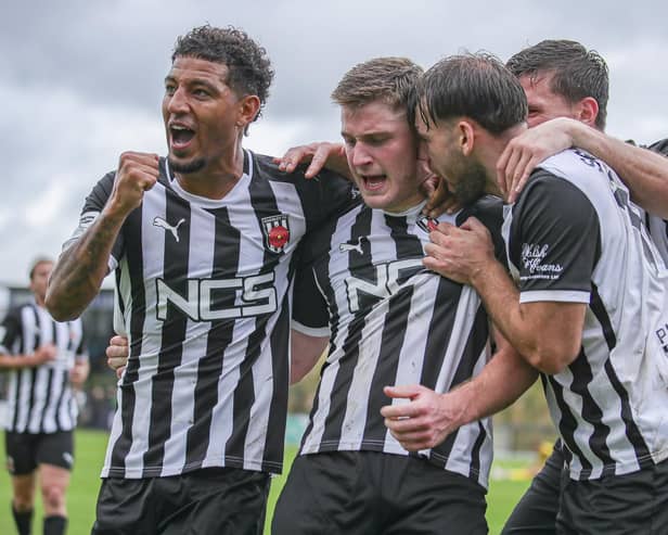 Elliot Taylor is mobbed after his equaliser against Brackley Town