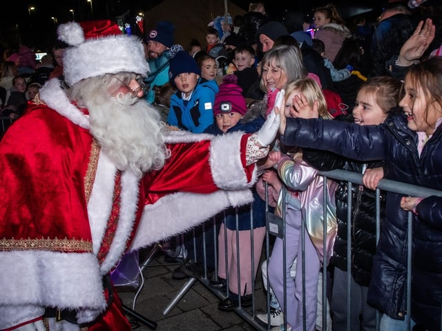 The smiles say it all as Father Christmas lands