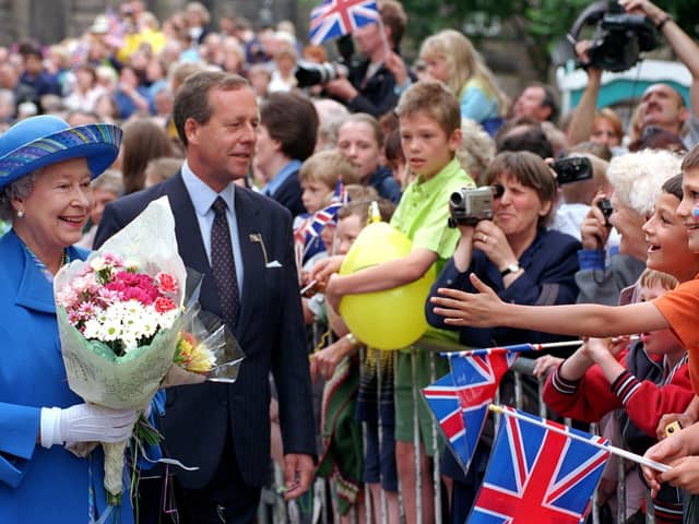The Queen meets the crowds in Market Street, Lancaster, in 1999.