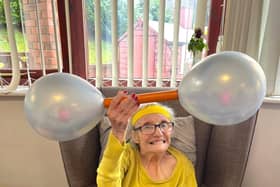 Resident Joyce enjoyed balloon weightlifting