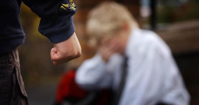 A posed image simulating a child being bullied.