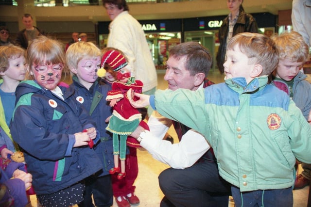 Mr Punch - despite his angry image - charms these youngsters at the Save the Children party held to celebrate the 75th year of the fund. At the bumper party at St George's shopping centre, Preston, the fun included having your face painted and watching Punch give Judy a bad time