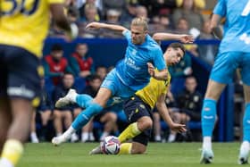 Preston North End's Brad Potts competing with Oxford United's Ruben Rodrigues 