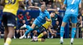 Preston North End's Brad Potts competing with Oxford United's Ruben Rodrigues 
