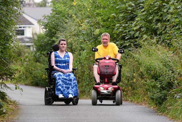 Ava Jolliffe and neighbour Simon Penney on Castle Lane which they fear they will struggle to use      Photo: Kelvin Stuttard