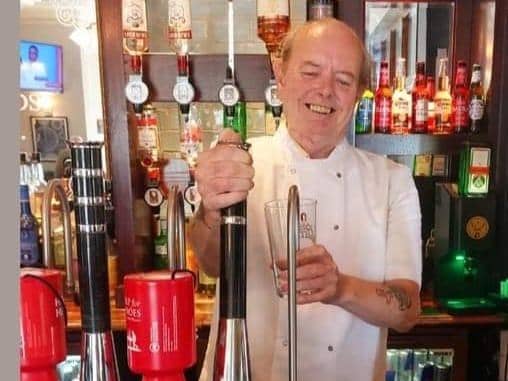 Lever Edge Care Home resident John Gorner, 70, pulling a pint at The Southfields.