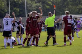 Chorley midfielder Mike Calveley holds his head in his hands as Milan Lalkovic (hidden) is sent off (photo: David Airey/dia_images)