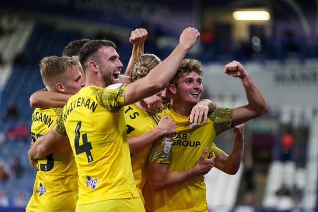 PNE players celebrate the fourth goal.