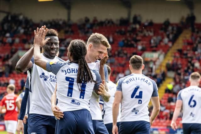 Preston North End midfielder Daniel Johnson celebrates scoring his side's second goal with team mate Bambo Diaby and Emil Riis
