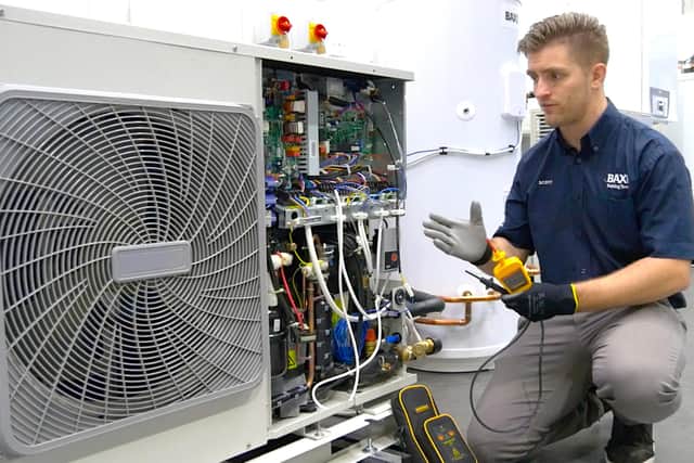 A Baxi engineer with air source heat pump