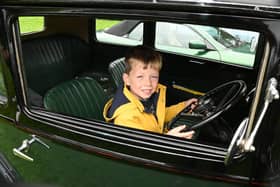 Wilson Murray, four, tries out a vintage vehicle.