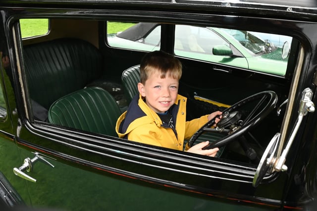 Wilson Murray, four, tries out a vintage vehicle.