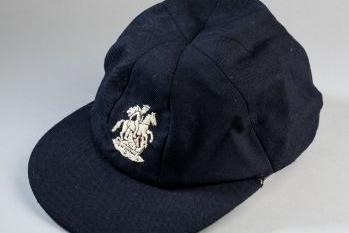 The navy blue wool cap comes with embroidered George & the Dragon crest with interior label inscribed D. Lloyd