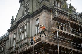 Workmen erecting scaffolding on the former Post Office building in Preston City Centre