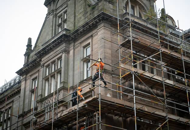 Workmen erecting scaffolding on the former Post Office building in Preston City Centre