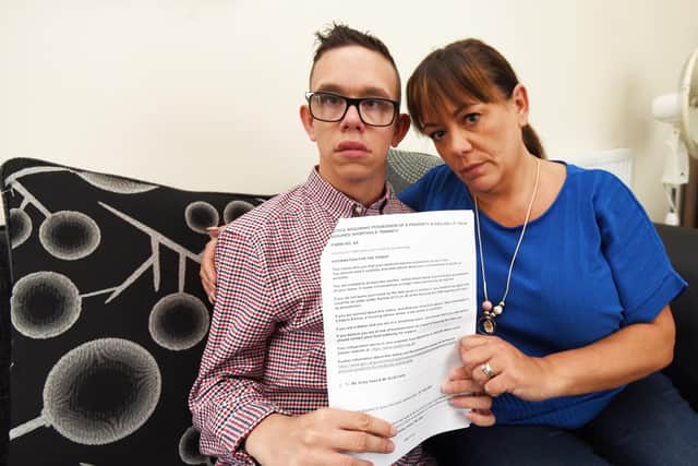 Vicky Carty and son Leo, who has a life-limiting condition, hold the legal notice telling them they must move