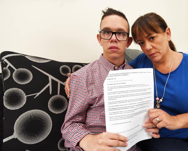 Vicky Carty and son Leo, who has a life-limiting condition, hold the legal notice telling them they must move