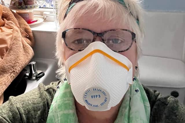 Gail Norris says she wears a mask inside her home because of mould