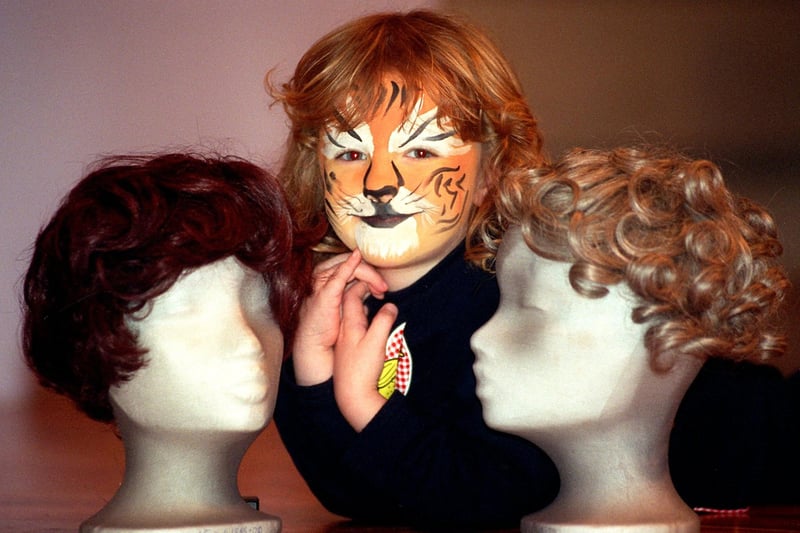 Three-year-old Carey Baptist Child Care Centre pupil Becky Smith poses amongst the exhibits in the Harris Museum's Body Ornament exhibition after having her face painted by students from Preston College