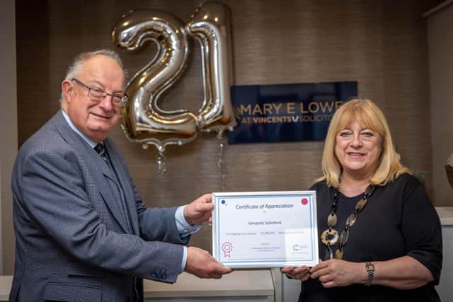 Helen Souter from Cancer Research UK thanks Vincents Solicitors' Chris Mathews for 21 years of help