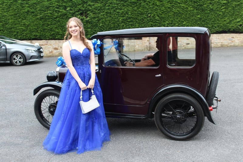 A young lady arrives in a classic car