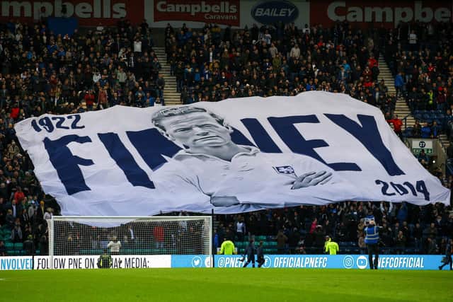 Preston North End fans in the Town End with a giant Sir Tom Finney surfer flag