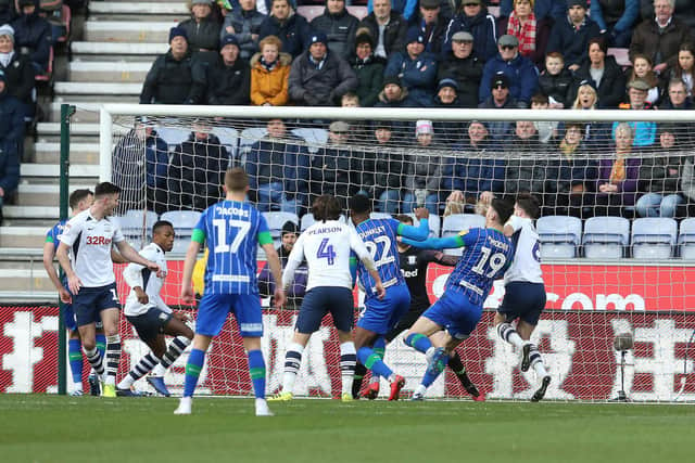 A scramble results in Cedric Kipre getting a goal back for Wigan.