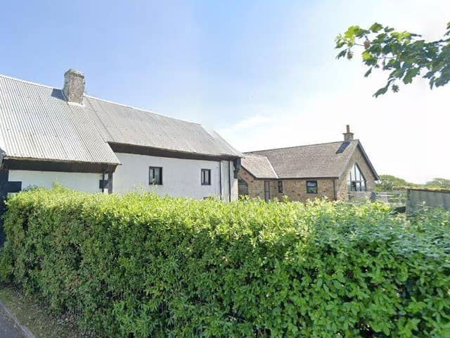 The white cottage-style property at Bourne Brow Farm should have been demolished before the new dwelling behind it was built in 2011 - but now it can remain (image: Google)
