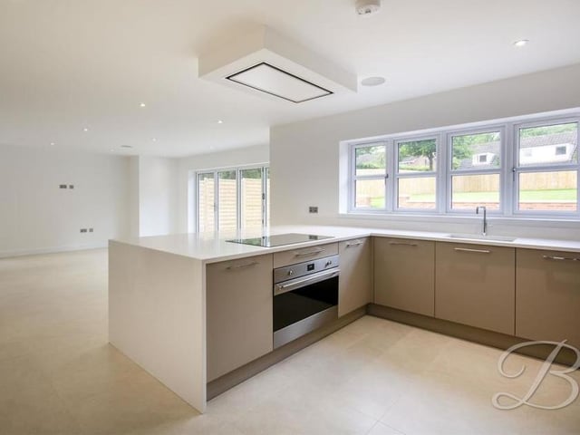 Not only is the kitchen beautiful, it is also bright, with windows to the front and side of the property. Here you can see the induction hob with extractor fan above.