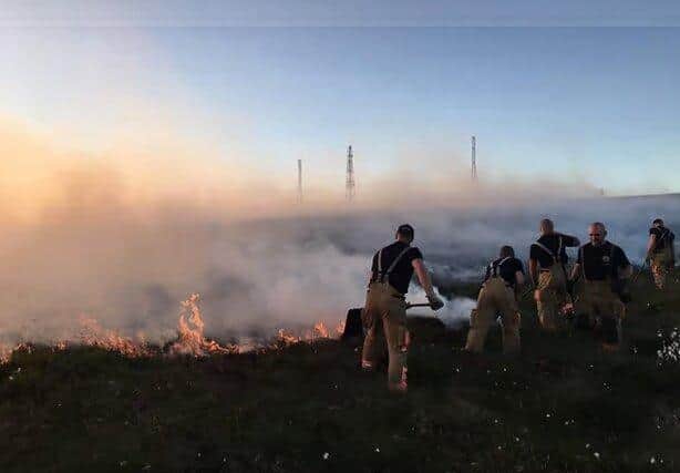 Firefighters battling the weeks-long blaze on Winter Hill in 2018