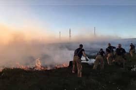 Firefighters battling the weeks-long blaze on Winter Hill in 2018