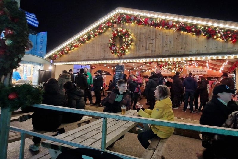 People enjoy a drink inside the cosy traditional German beer tent