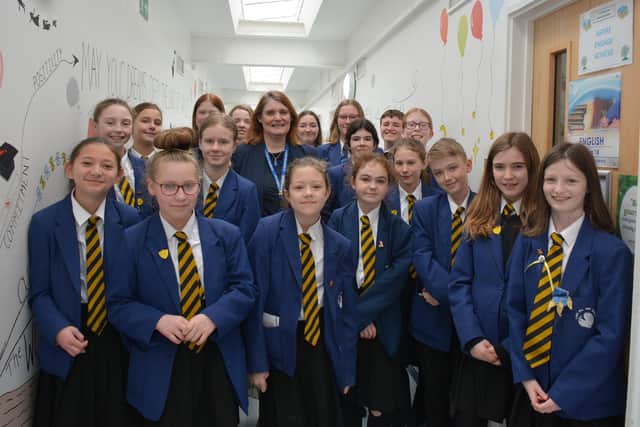 The clubs are led by Ms Fry (centre) who says she is very proud of the pupils' commitment.