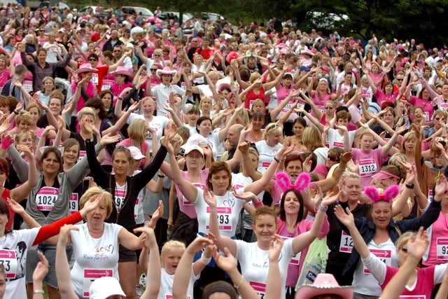 Runners warming up prior to the start of the Race For Life at Worden Park, Leyland