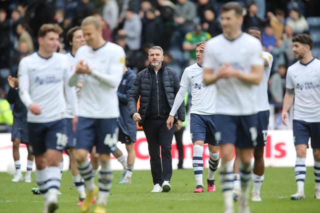 Ryan Lowe amongst a crowd of first team players
