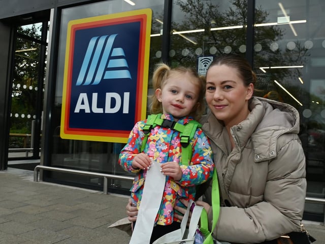Happy shoppers Amy Waddington and Alyza, three, outside the newly opened Aldi supermarket.