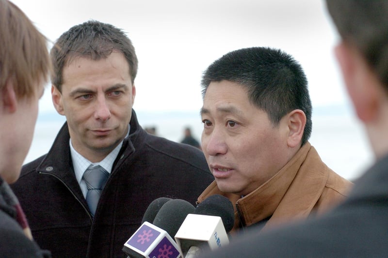 Divisional director of the Chinese Criminal Investigating Department Dr Zuo Zhijin is interviewed by the media, watched by DCI Steve Brunskill, during a visit to Morecambe by Chinese detectives.
