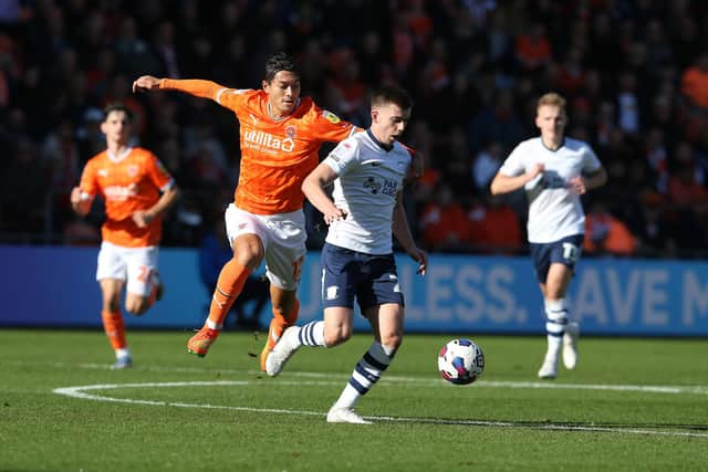 Preston North End's Ben Woodburn shields the ball from Blackpool's Kenny Dougall 

The EFL Sky Bet Championship - Blackpool v Preston North End - Saturday 22nd October 2022 - Bloomfield Road - Blackpool